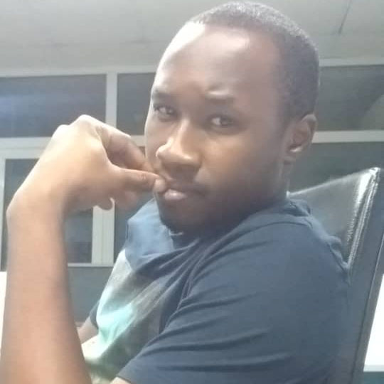 Mayowa Larmie sitting and looking sideways at the camera
