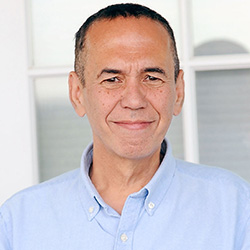  Gilbert Gottfried putting on a sky blue shirt smiling