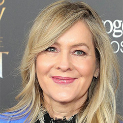 Linda Larkin with a pink lipstick smiling