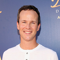 Scott Weinger wearing a white shirt smiling